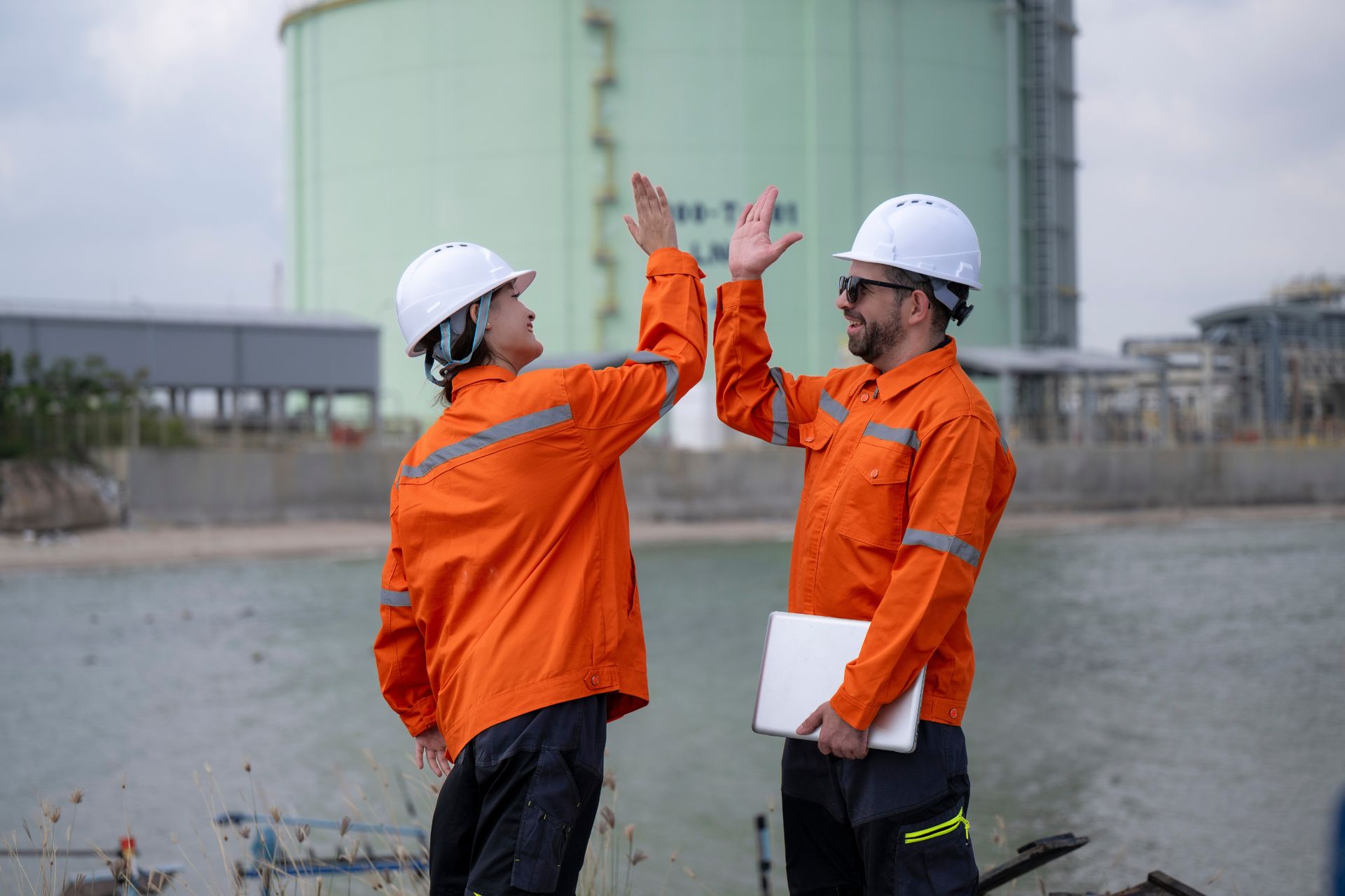 two construction workers high fiving each other
